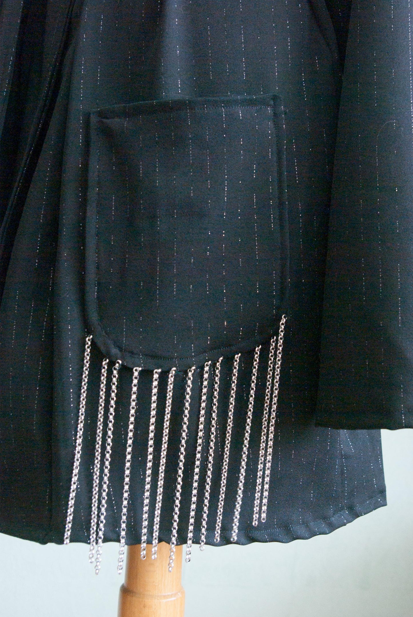 Silver plated chains as fringe on the pockets