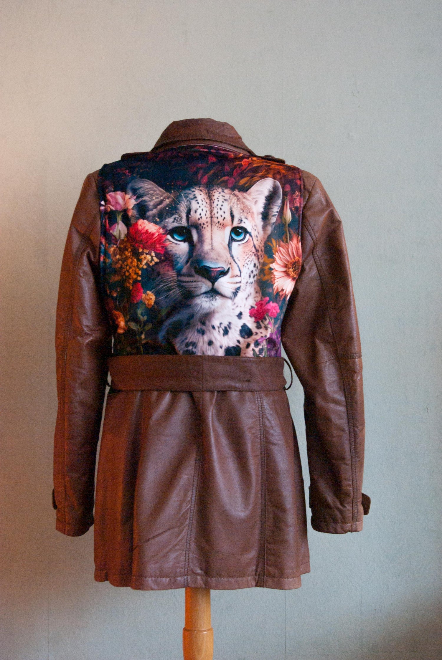 Brown leather trenchcoat with a velour panther animal on the back. 
