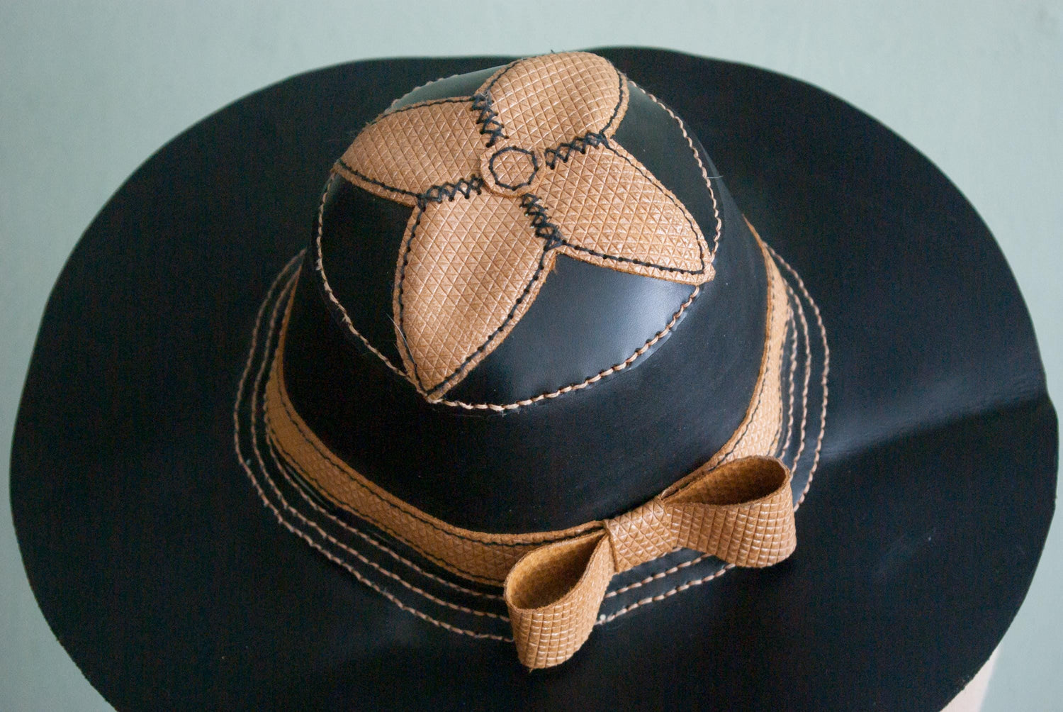 Handcrafted & hand-stitched black and gold leather summer hat. 