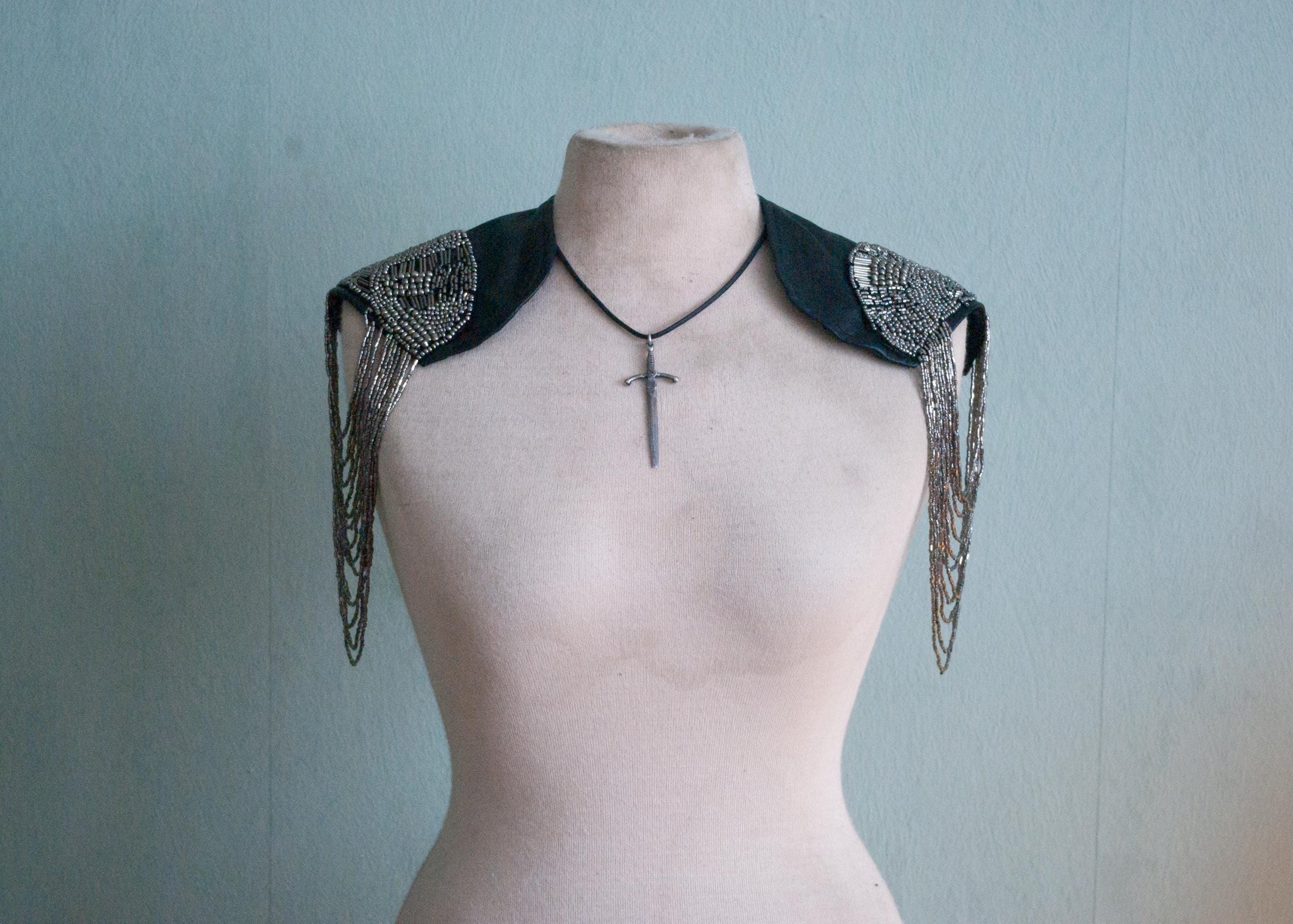 The front of the Soft black leather shoulder pauldrons with epaulettes, made of silver beads