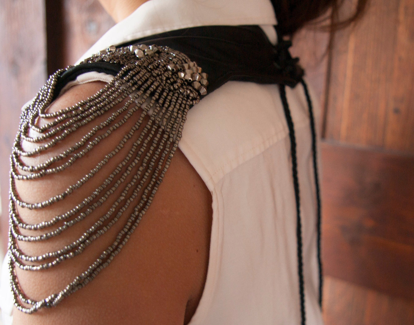 Details of the Soft black leather shoulder pauldrons with epaulettes, made of silver beads