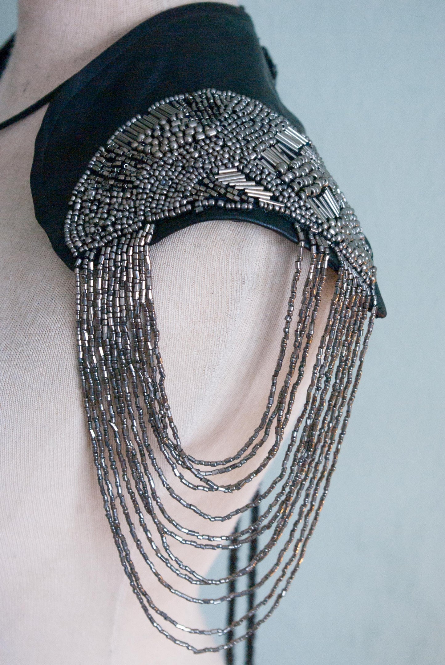 Soft black leather shoulder pauldrons with epaulettes, made of silver beads