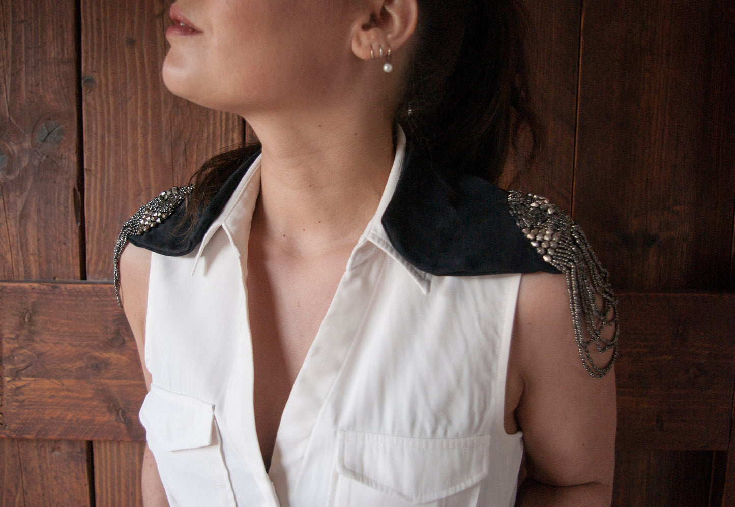 A model wearing the Soft black leather shoulder pauldrons with epaulettes, made of silver beads