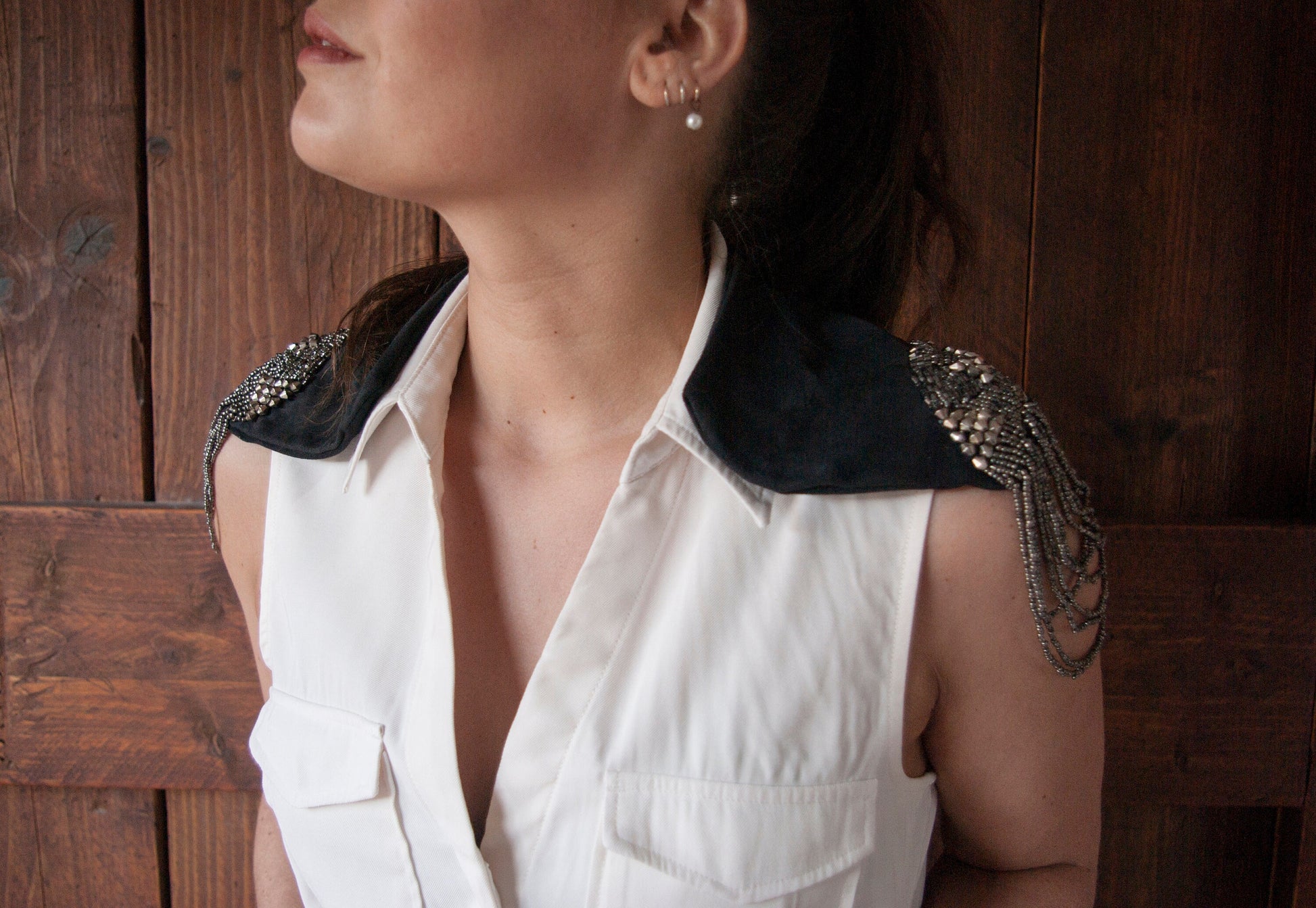 A model wearing the Soft black leather shoulder pauldrons with epaulettes, made of silver beads