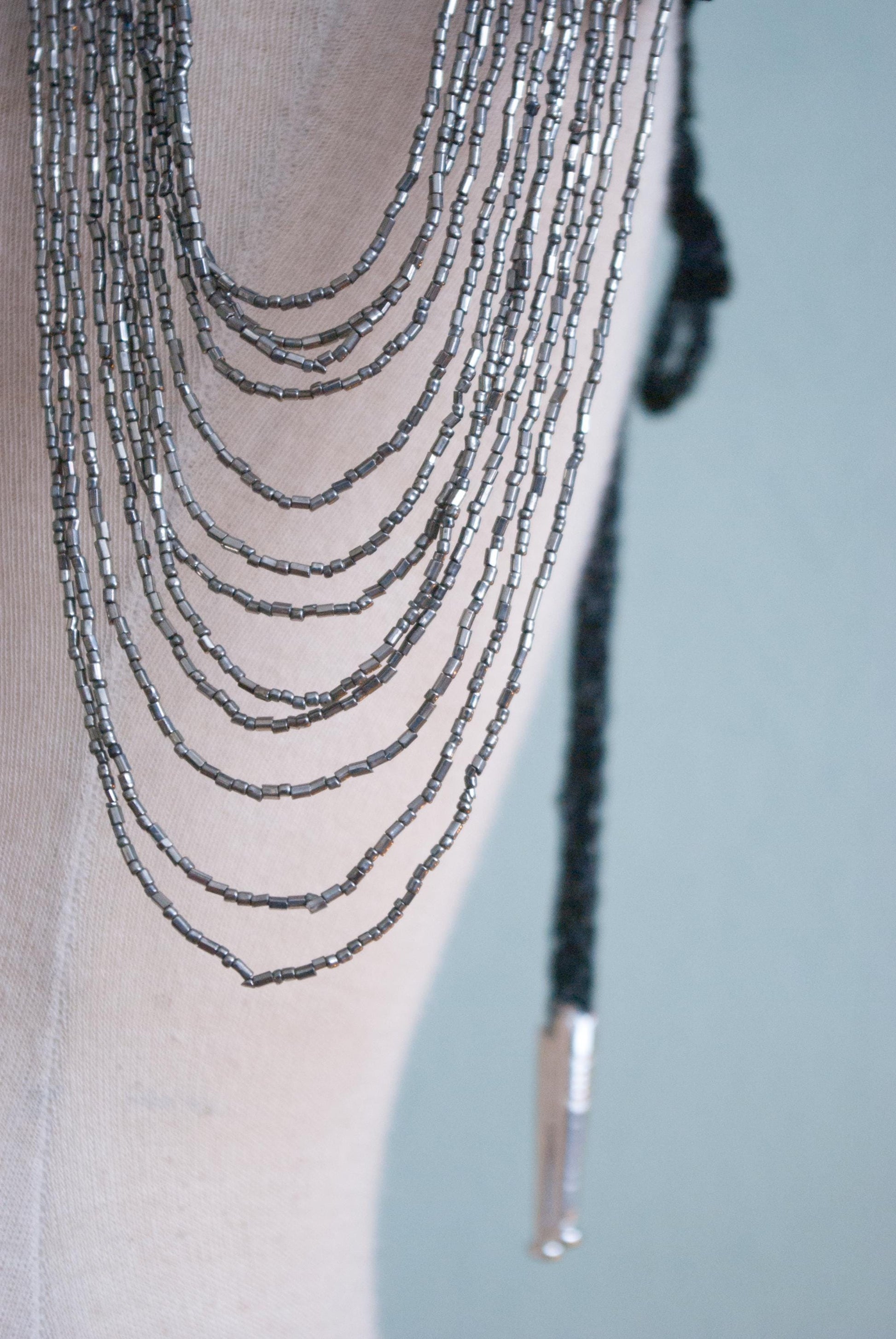 Soft black leather shoulder pauldrons with epaulettes, made of silver beads