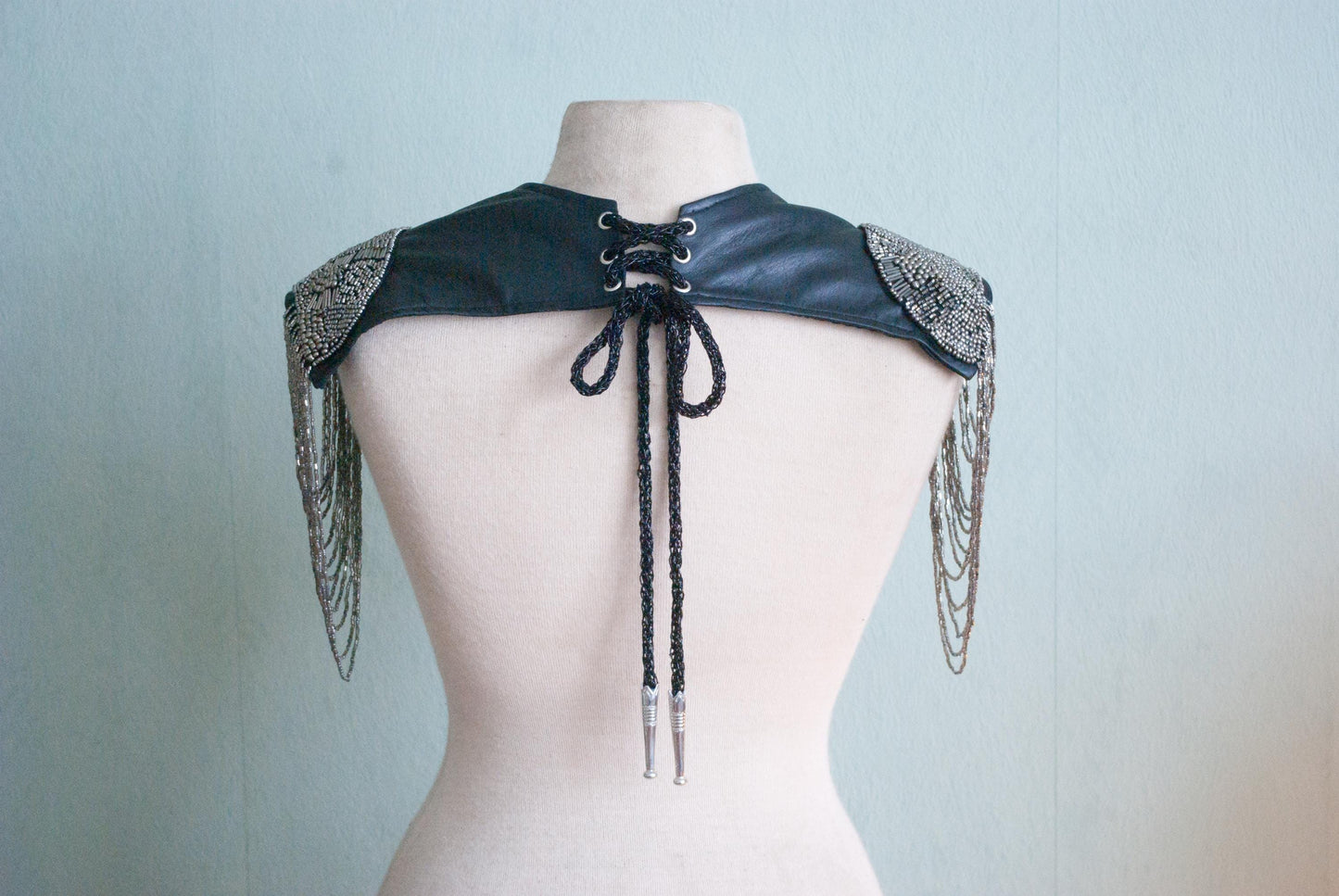 Backside of the Soft black leather shoulder pauldrons with epaulettes, made of silver beads
